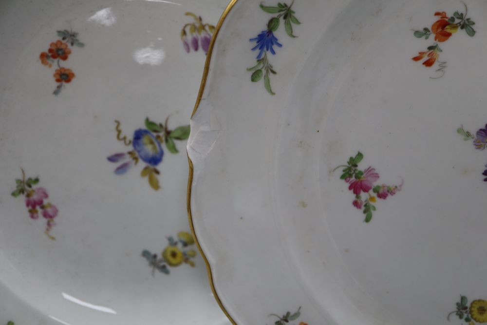 Three Meissen floral and gilt decorated plates, diameter 24cm